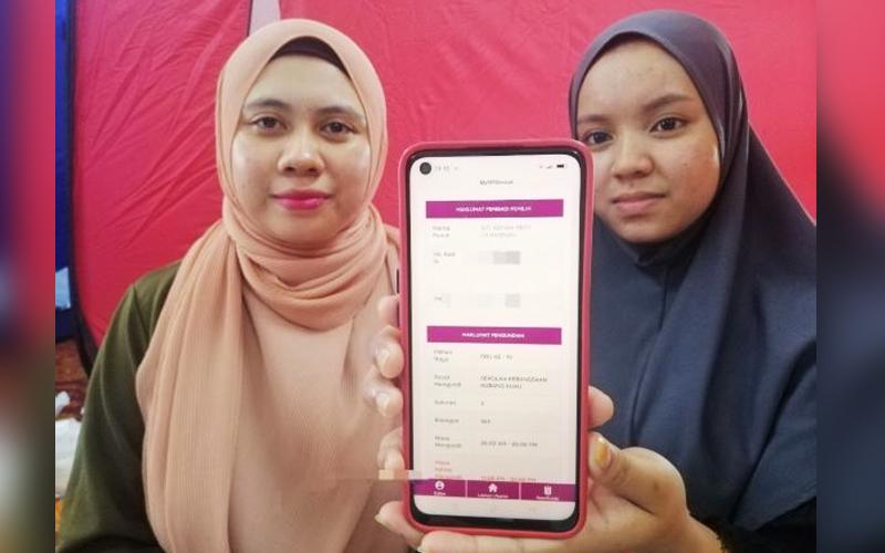 From KL to Kelantan, siblings spend the night at relief centre to vote