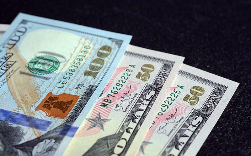 Dollar holds steady, eyes PMI data for rate insights