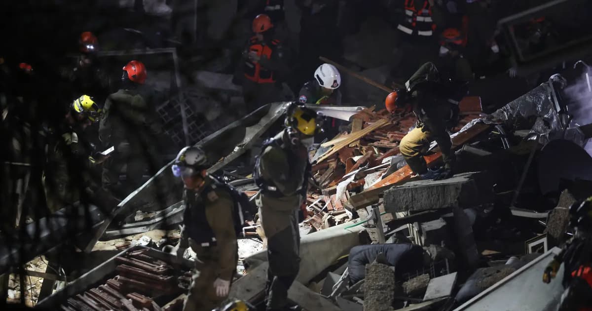 Israeli rescuers search for missing people after building hit by Iranian missile