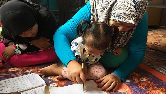 Ridzawati with her youngest child, aged two.