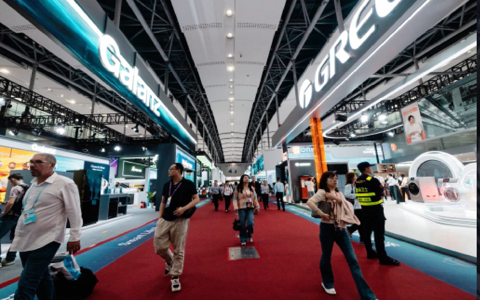 People walk in front of the Galanz and Green booths during the 139th Canton Fair in Guangzhou, Guangdong province, China, 15 April 2026. The 139th edition of the China Import and Export Fair, also known as the Canton Fair, runs from 15 April to 05 May 2026, showcasing a wide range of industries including electronics, manufacturing, and consumer goods. As China's largest trade event, it features over 30,000 exhibitors and attracts buyers from across the globe to the Canton Fair Complex.