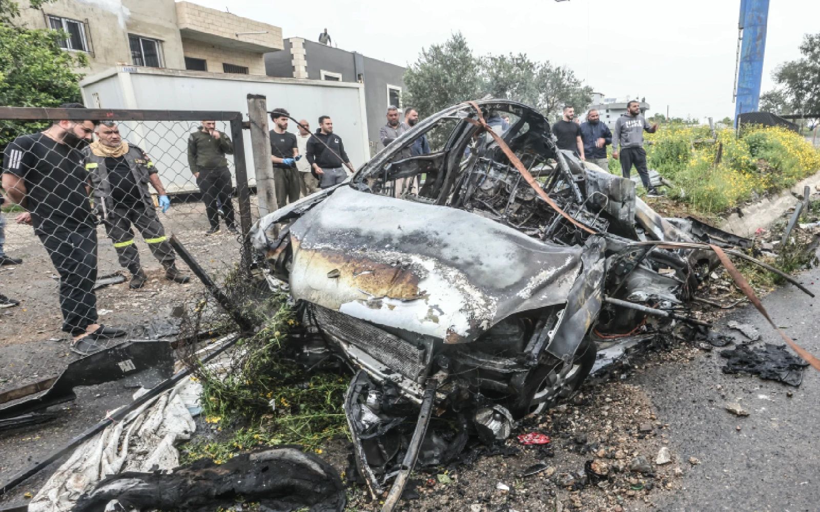 First responders and security forces work at the site of an Israeli airstrike that targeted a vehicle the Lebanese town of Jiyeh, south of Beirut, on April 15, 2026.