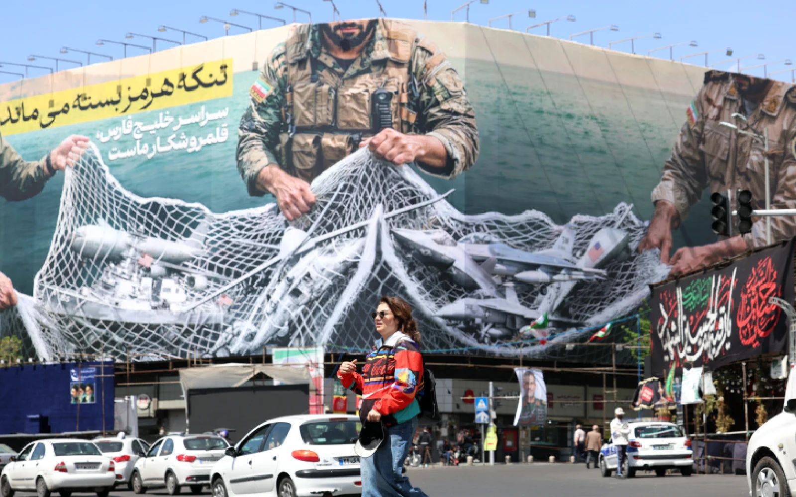 Traffic passing a huge political billboard reading in Persian ’The Strait of Hormuz will remain closed', in Enghelb square in Tehran, Iran, 05 April 2026. Iran's Revolutionary Guards (IRGC) said a US aircraft that had been searching for the crew member of a missing US fighter jet had been destroyed, Iranian media reported on 05 April 2026. EPA/ABEDIN TAHERKENAREH
