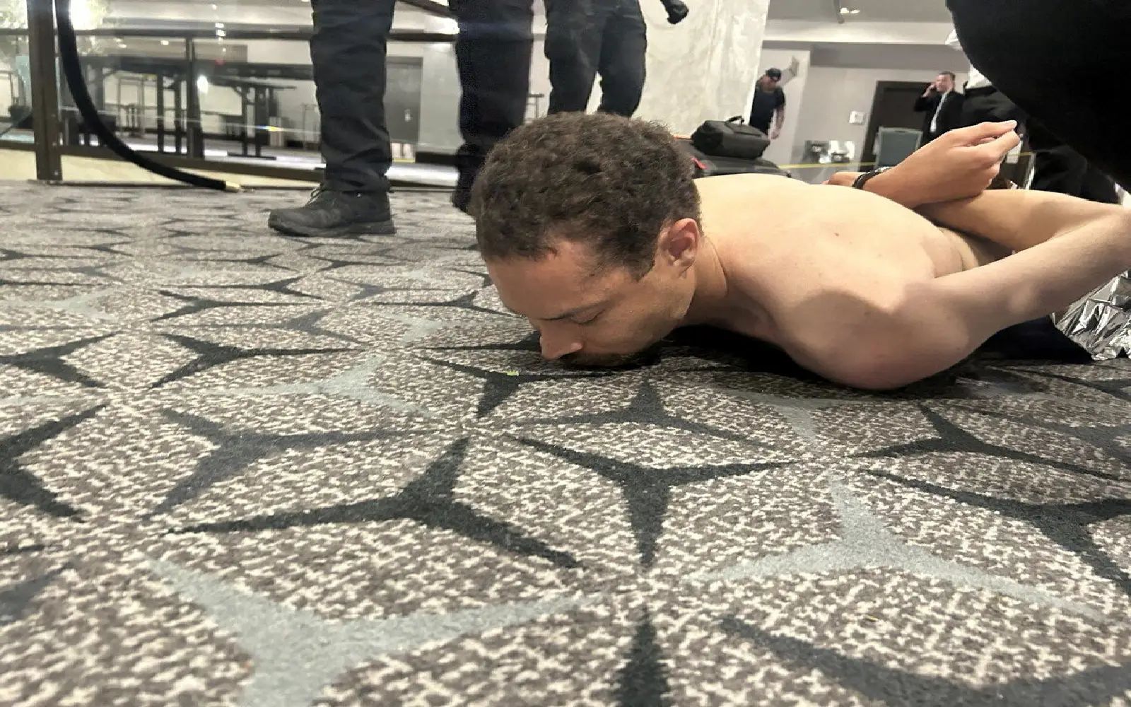 Law enforcement personnel detain Cole Tomas Allen, a suspect in the shooting incident at the White House Correspondents' Association dinner, in Washington, D.C., U.S. April 25, 2026. DONALD J TRUMP via Truth Social/Handout via REUTERS THIS IMAGE HAS BEEN SUPPLIED BY A THIRD PARTY. NO RESALES. NO ARCHIVES. MANDATORY CREDIT. REFILE -