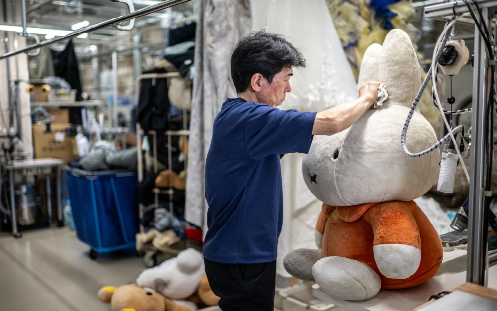 dry-cleaning professional Masakazu Shimura cleans a soft toy at the facility of Cleaning Yonmarusan in Fuefuki city of Yamanashi Prefecture.