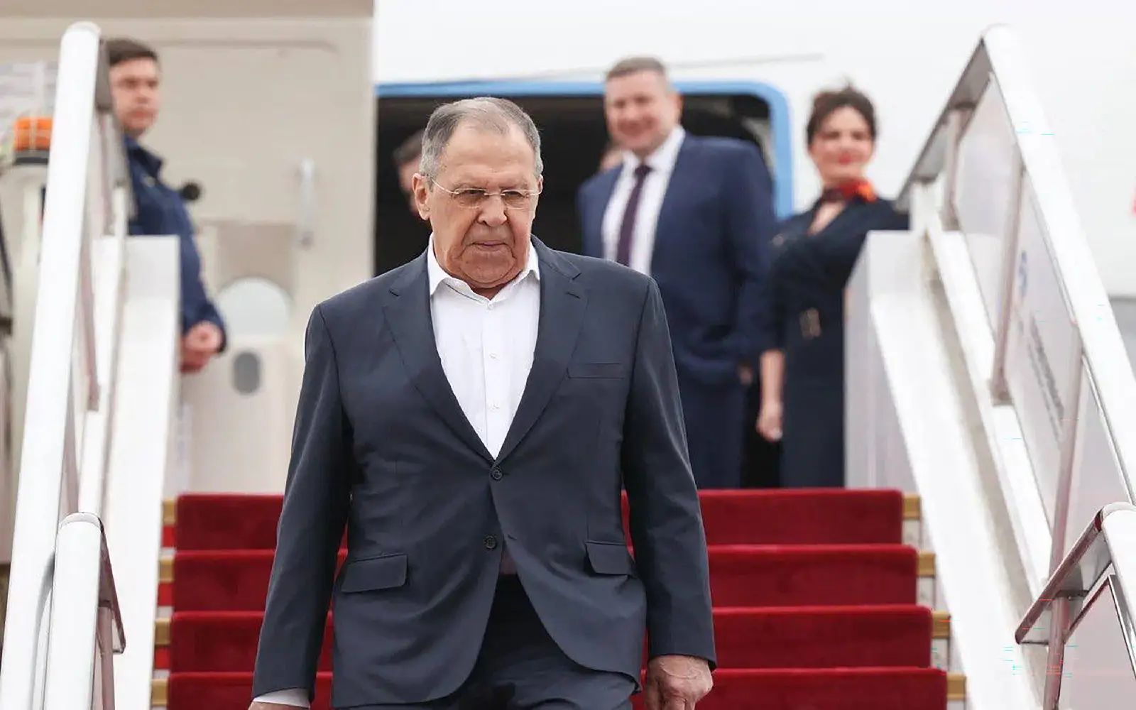 This handout photograph taken and released by the Russian Foreign Ministry on April 14, 2026 shows Russia's Foreign Minister Sergei Lavrov disembarking from a plane as he arrives in Beijing. (Photo by Handout / RUSSIAN FOREIGN MINISTRY / AFP
