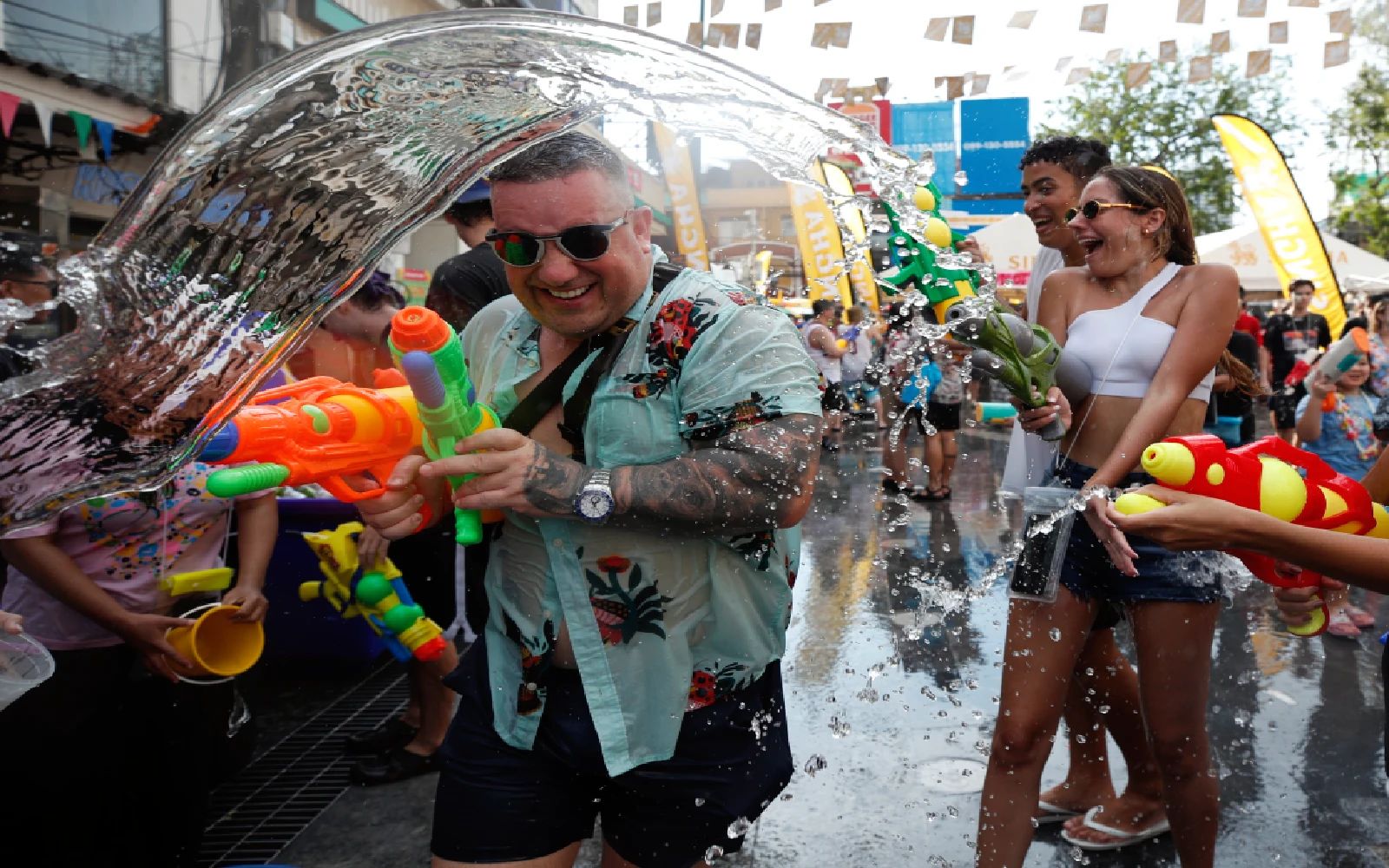 Foreign tourists take part in the water gun battle to celebrate the annual Songkran festival, the Thai traditional New Year celebrations also known as the water festival at the tourist spot Khao San road in Bangkok, Thailand, 13 April 2025. 