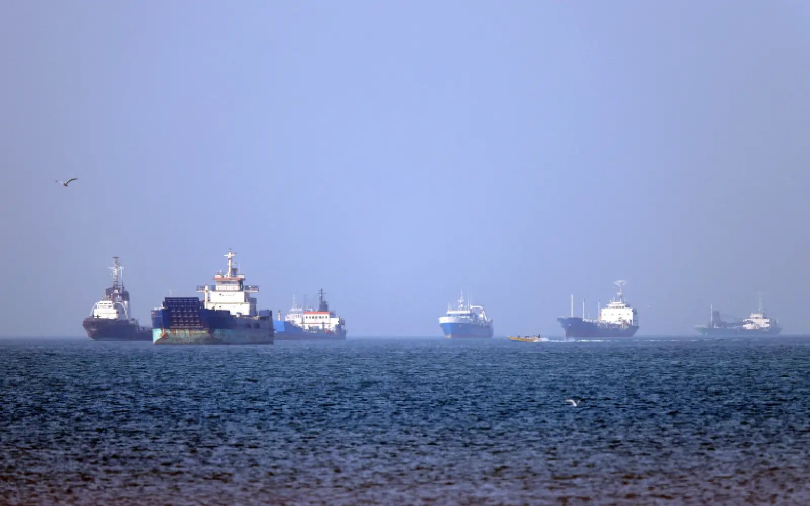 In this picture obtained from Iran's ISNA news agency on May 4, 2026, vessels are pictured anchored in the Strait of Hormuz off Bandar Abbas in southern Iran. Iran's Revolutionary Guards on May 4 denied that any commercial ships had crossed the Strait of Hormuz, after the US military earlier said two US-flagged merchant vessels had transited through the vital waterway.