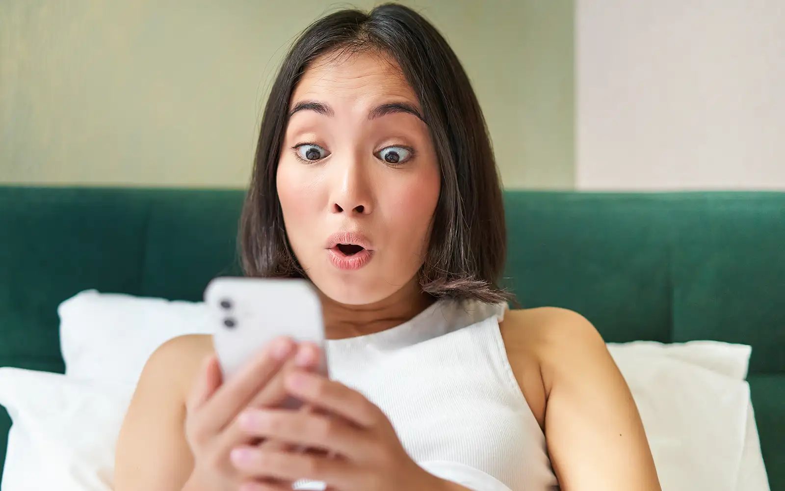 woman staring at her smartphone with a shocked look (Envato Elements pic) 14526