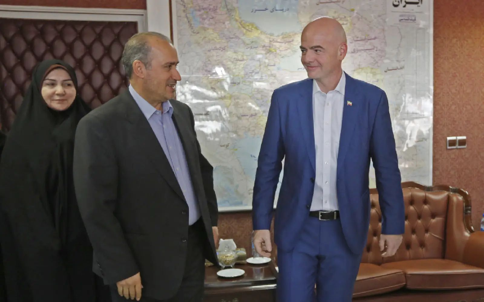 Iranian Football Federation President Mehdi Taj (2nd-L) talks to FIFA President Gianni Infantino during the latter's visit to the capital Tehran on March 1, 2018. (Photo by ATTA KENARE / AFP)