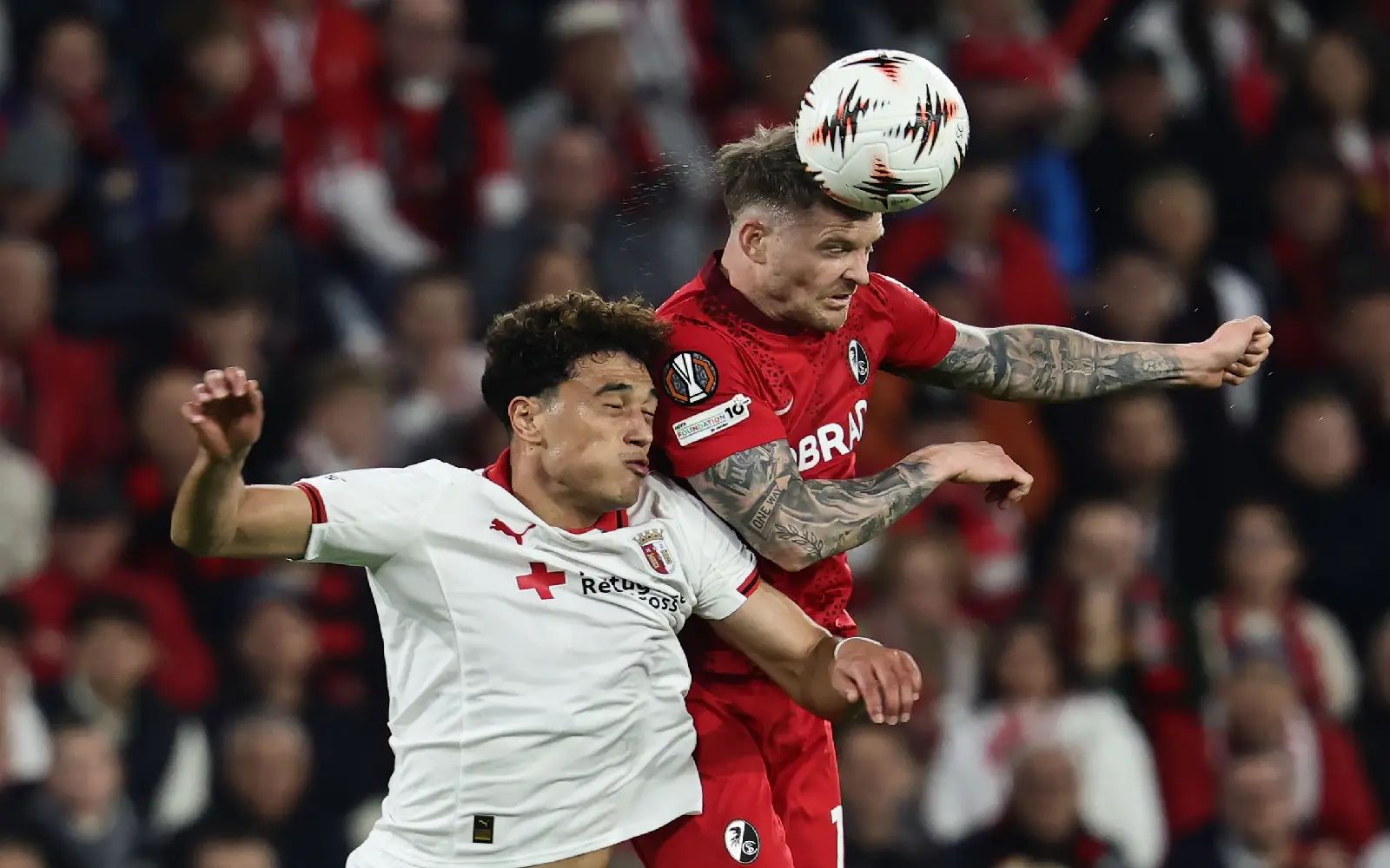 Vitor Carvalho of Braga (L) and Lukas Kuebler of Freiburg (R) in action during the UEFA Europa League semi-finals 2nd leg match SC Freiburg against SC Braga, in Freiburg, Germany, 07 May 2026. EPA/RONALD WITTE