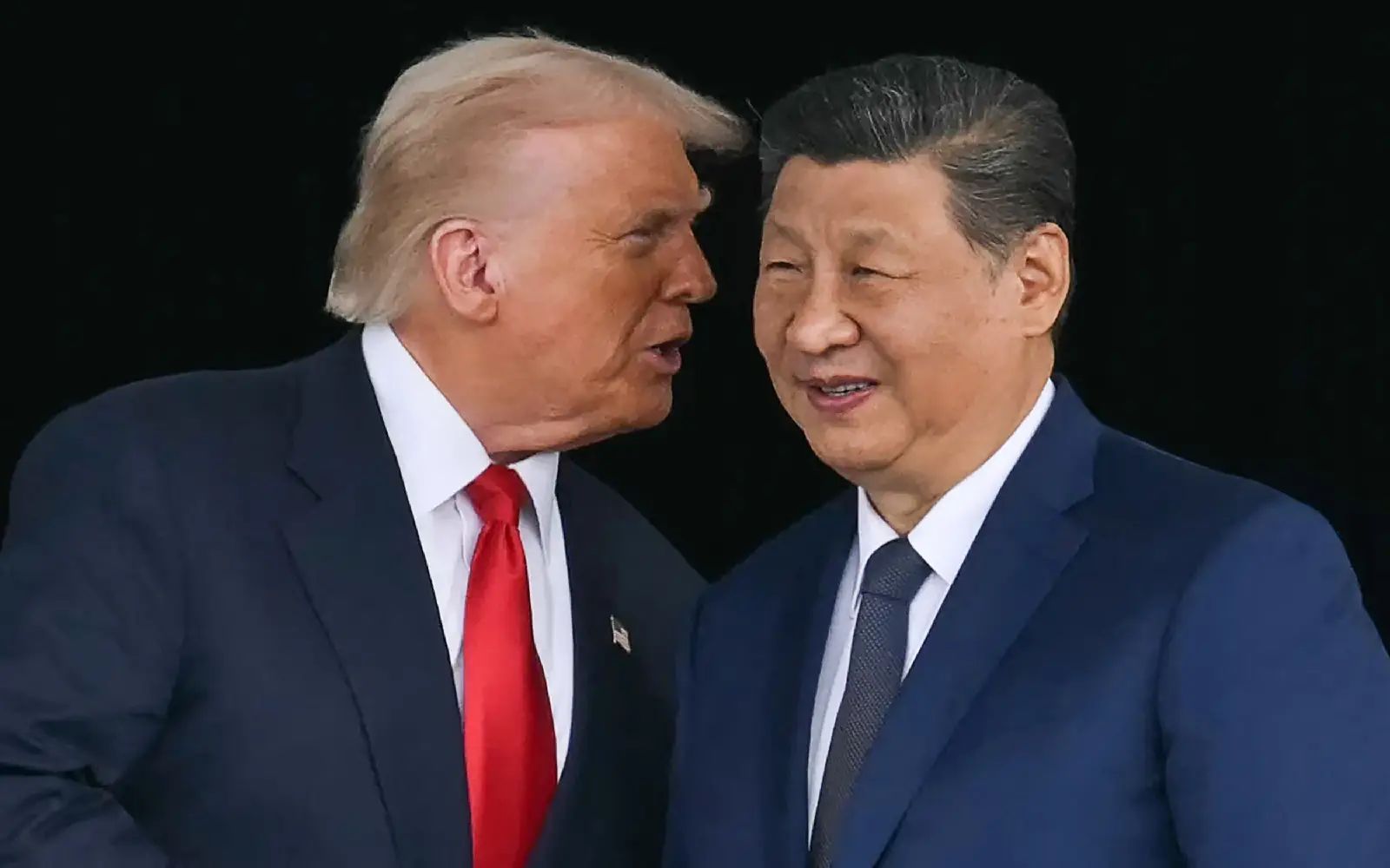 US President Donald Trump (L) talks to China's President Xi Jinping as they shake hands after their talks at the Gimhae Air Base, located next to the Gimhae International Airport in Busan on October 30, 2025.