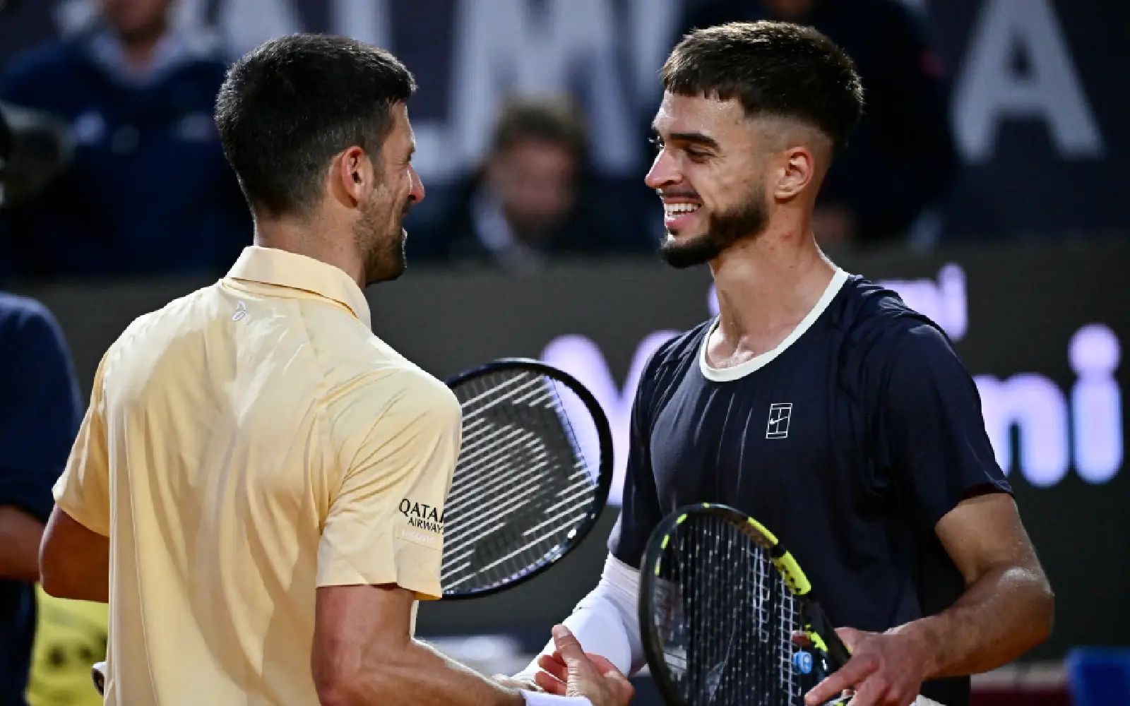 Croatia's Dino Prizmic (R) shakes hands with Serbia's Novak Djokovic after winning their men's singles match of the WTA Rome Open tennis tournament at the Foro Italico in Rome on May 8, 2026. (Photo by Filippo MONTEFORTE / AFP)