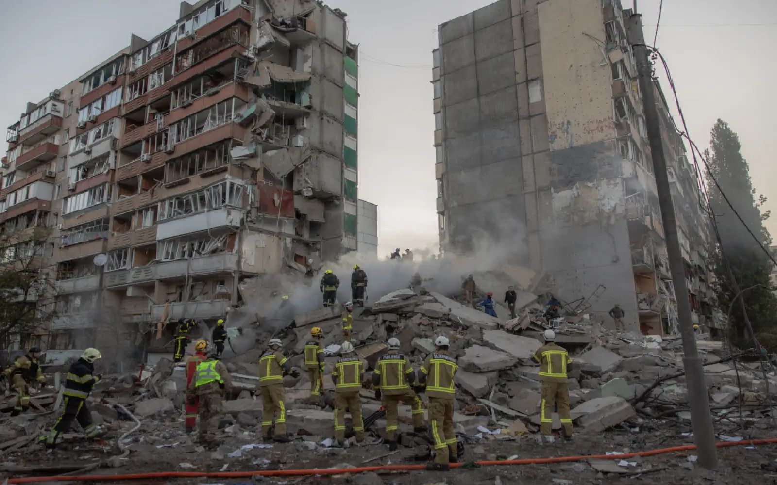 Rescuers work at a residential building partially destroyed following Russian drone and missile strikes in Kyiv on May 14, 2026, amid the Russian invasion in Ukraine. Ukraine's capital came under heavy aerial attack early on May 14, an AFP journalist reported, as Kyiv's mayor said Russia was striking the city.