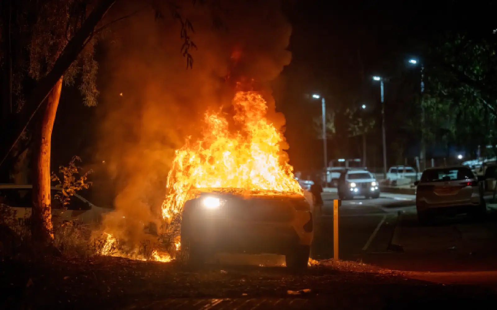 A police vehicle is set alight after community members clashed with police outside Alice Springs Hospital, where a man accused of abducting and killing five-year-old Kumanjayi Little Baby was taken after being arrested, in Alice Springs, Thursday, April 30, 2026.