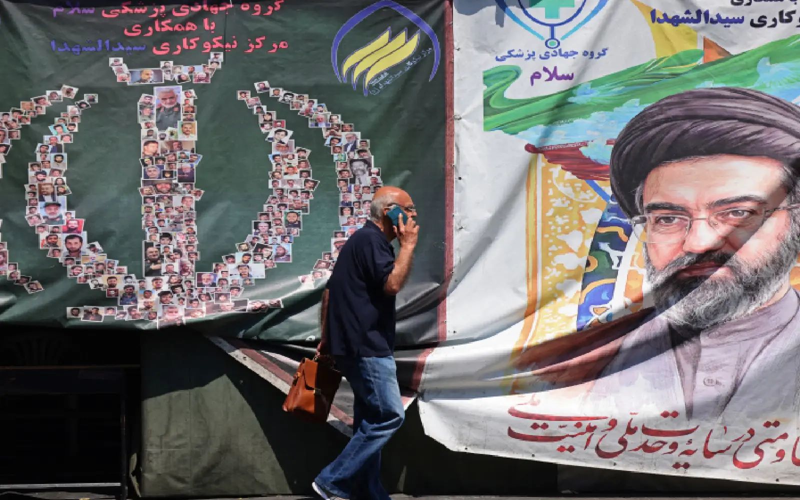 A man walks past a banner installed along the roadside of Iran's supreme leader Ayatollah Mojtaba Khamenei, in Tehran on April 29, 2026. US President Donald Trump on April 29 warned Iran to "better get smart soon" as efforts by Washington and Tehran to end hostilities appeared at a standstill.