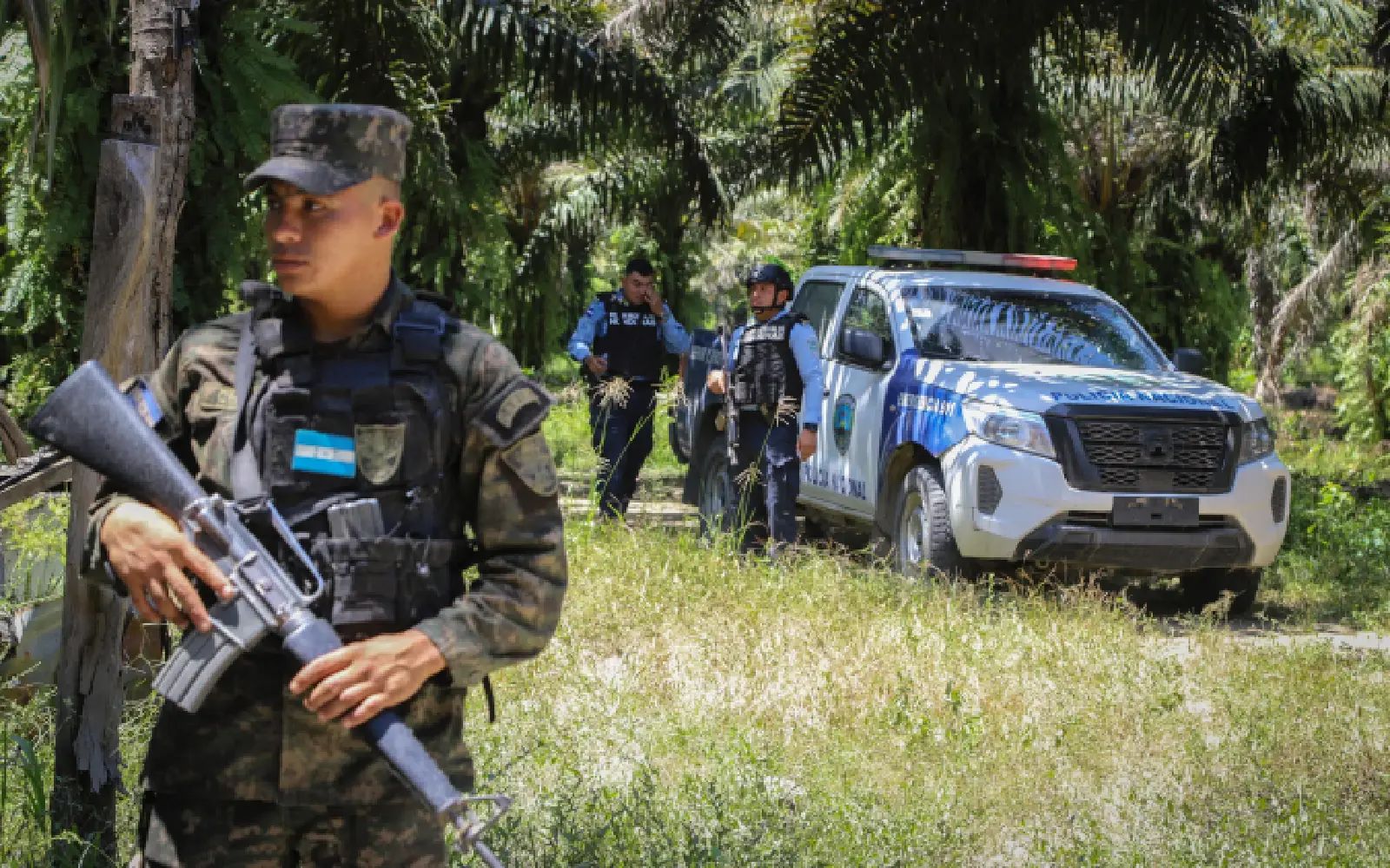Honduran soldiers and police officers guard the site of a massacre in Trujillo, Honduras on May 21, 2026. Several people were massacred in a town in northern Honduras where rival gangs are fighting for control of palm oil plantations, authorities and residents said on May 20, 2026.