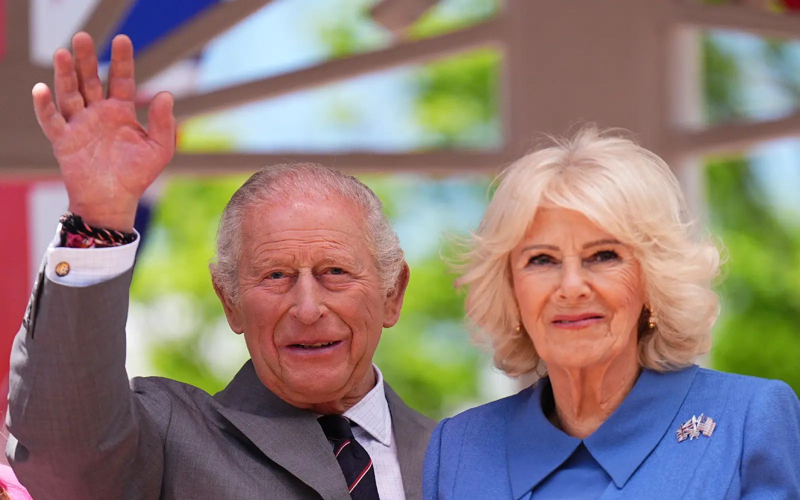 Britain's King Charles waves next to Queen Camilla during a parade and block party in Front Royal, Virginia, 
