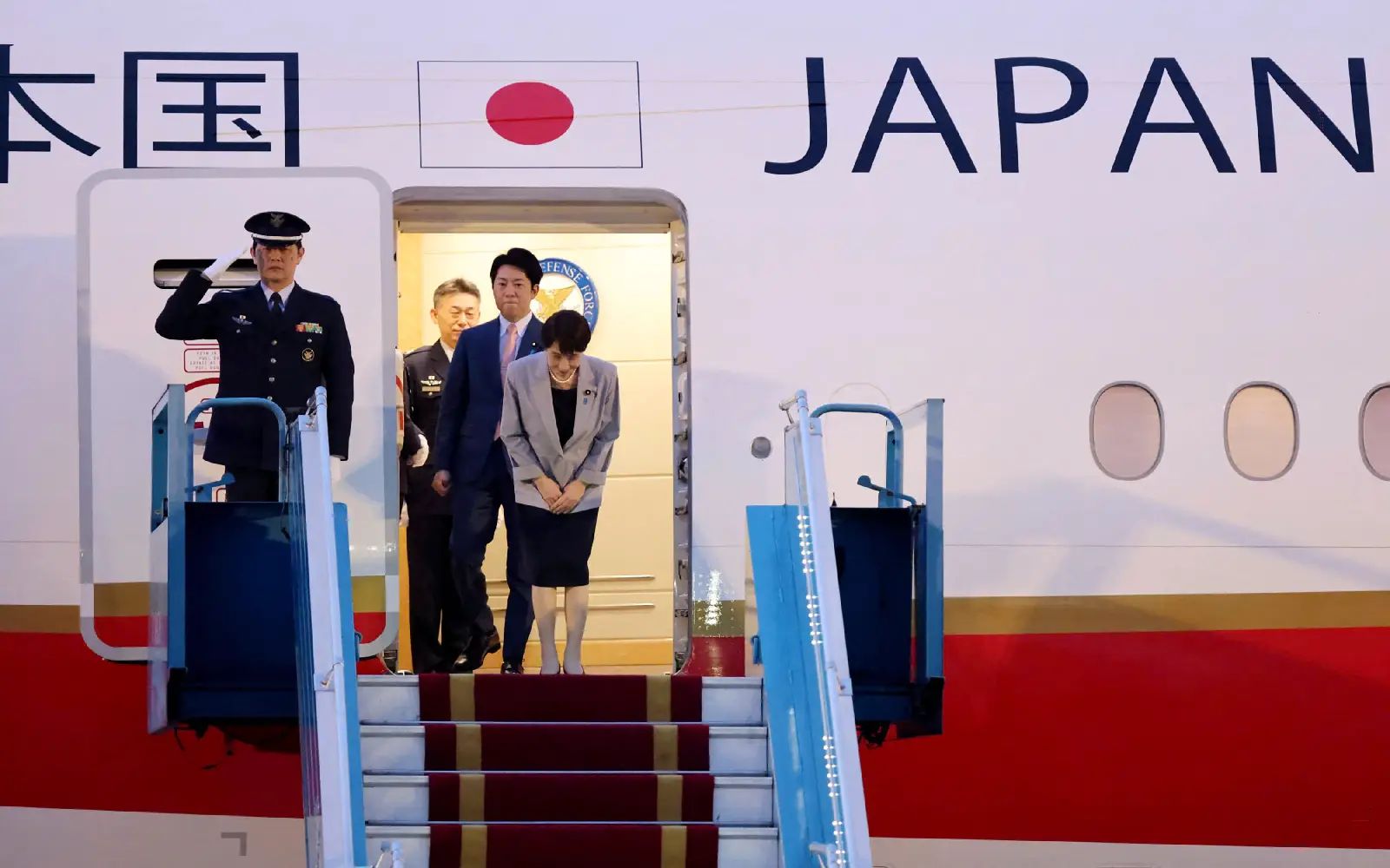 Japan's Prime Minister Sanae Takaichi (R) bows as she disembarks a plane upon her arrival at Noi Bai International Airport in Hanoi on May 1, 2026.