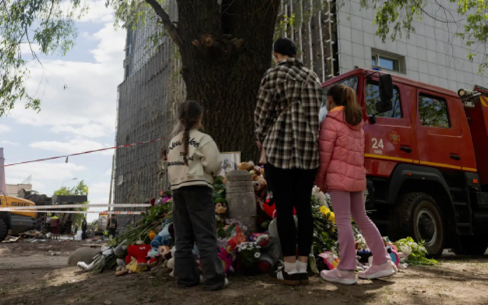 Local residents are standing at a makeshift memorial near a partially destroyed residential building in Kyiv on May 15, 2026, amid the Russian invasion of Ukraine. Ukraine's capital Kyiv was in mourning on May 15, 2026, after a Russian attack killed 24 people a day earlier, with President Volodymyr Zelensky denouncing Moscow's "brutal terror" as the two sides went ahead with an exchange of hundreds of captured soldiers.
