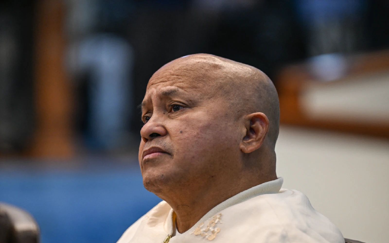 Philippine Senator Ronald Dela Rosa reacts as he talks to the media before the start of a plenary session at the Senate of the Philippines in Pasay, Metro Manila on May 12, 2026. (Photo by Jam STA ROSA / AFP)