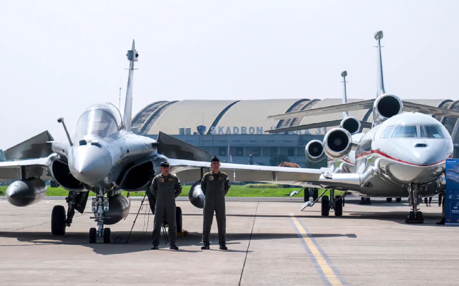 Fighter pilots stand near aircrafts during a ceremony to hand over six new Rafale jet fighters, six Dassault Falcon 8X aircrafts and two Airbus A400M Atlas transport planes to the Indonesian Air Force at Halim Perdanakusuma Air Force Base in Jakarta on May 18, 2026. (Photo by BAY ISMOYO / AFP)