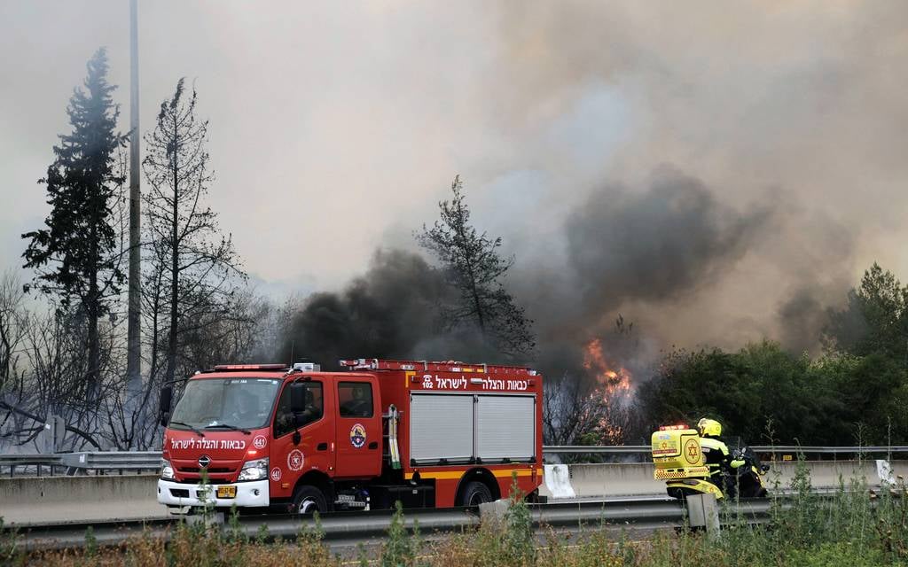 Israel reopens key roads as firefighters battle blaze
