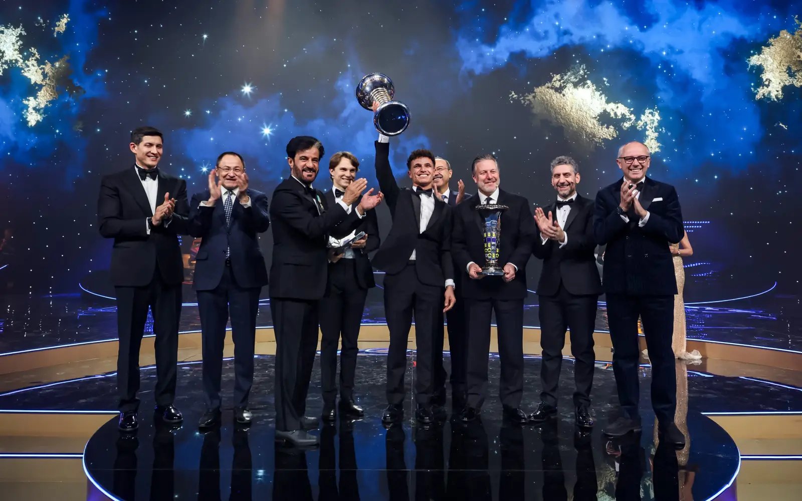 Norris gets his hands on F1 trophy as unwell Verstappen stays away