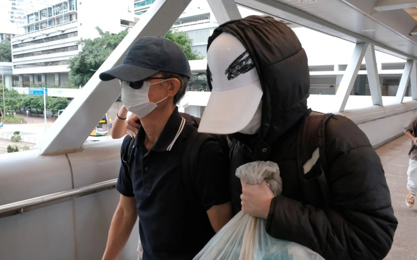 Hong Kong sentences father of wanted activist to 8 months in jail